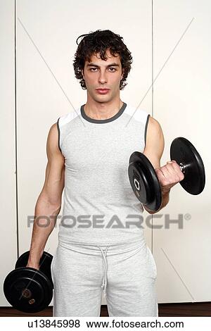 Young man lifting weights View Large Photo Image Stock Photo - Young man lifting weights. Fotosearch