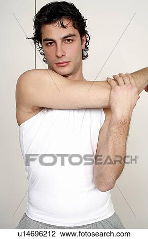 Stock Image - Young man stretching. Fotosearch