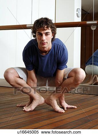 Stock Photography - Young man stretching. Fotosearch