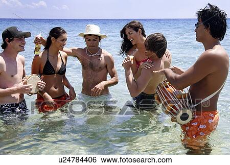 Stock Photograph - Group of friends in water having fun. Fotosearch