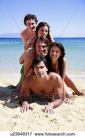 Stock Photo - Group of friends piling into a pyramid. Fotosearch