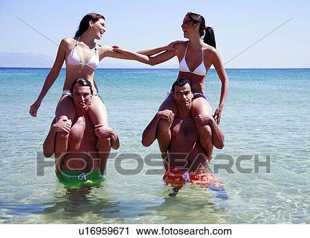 Group of friends playing in the water View Large Photo Image Stock Image - Group of friends playing in the water. Fotosearch