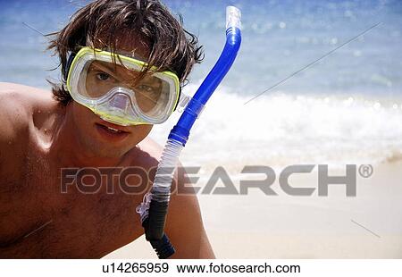Stock Photo - Man on beach with scuba mask. Fotosearch