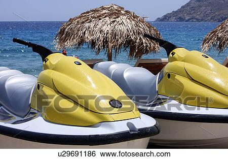 Two jetskis parked on beach View Large Photo Image Stock Photograph - Two jetskis parked on beach. Fotosearch