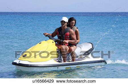 Young couple on jetski View Large Photo Image Stock Photo - Young couple on jetski. Fotosearch