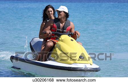 Stock Photo - Young couple on jetski. Fotosearch