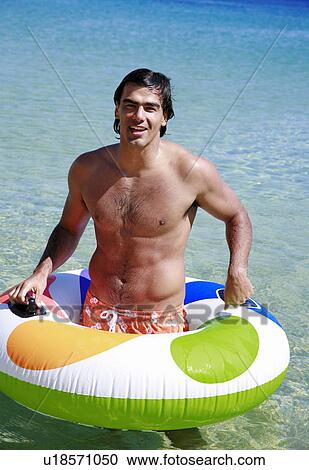 Man in the water with inflatable life ring View Large Photo Image Stock Image - Man in the water with inflatable life ring. Fotosearch