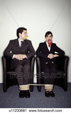 Stock Image - Male and female business people gagged and tied. Fotosearch