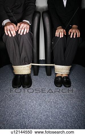 Male and female business people's legs tied View Large Photo Image Stock Image - Male and female business people's legs tied. Fotosearch