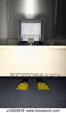 Office worker at computer wearing swim flippers View Large Photo Image Stock Photo - Office worker at computer wearing swim flippers. Fotosearch