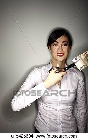 Picture - Office worker cutting a 50 euro bill. Fotosearch