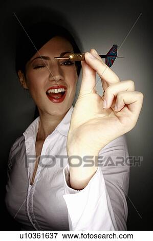 Office worker holding a dart View Large Photo Image Stock Photo - Office worker holding a dart. Fotosearch
