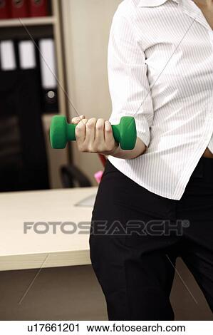 Stock Image - Office worker weight lifting. Fotosearch