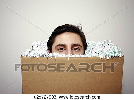 Stock Image - Office worker with head in a box. Fotosearch
