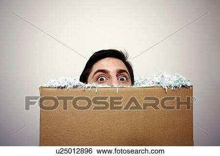 Stock Photograph - Office worker with head in a box. Fotosearch