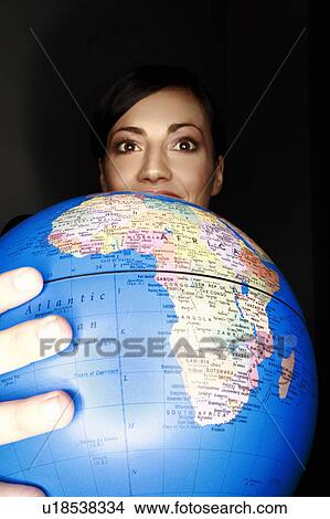 Picture - Woman holding globe. Fotosearch