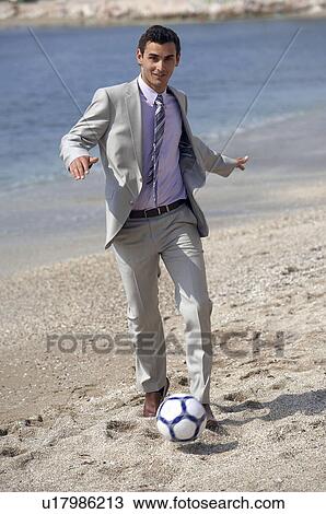 Businessman on beach playing soccer View Large Photo Image Stock Image - Businessman on beach playing soccer. Fotosearch