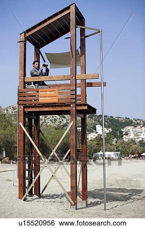 Businessman on life guard stand with binoculars View Large Photo Image Stock Photograph - Businessman on life guard stand with binoculars. Fotosearch