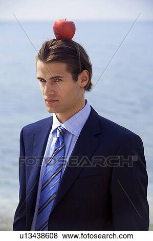 Businessman with apple balanced on his head View Large Photo Image Stock Photo - Businessman with apple balanced on his head. Fotosearch