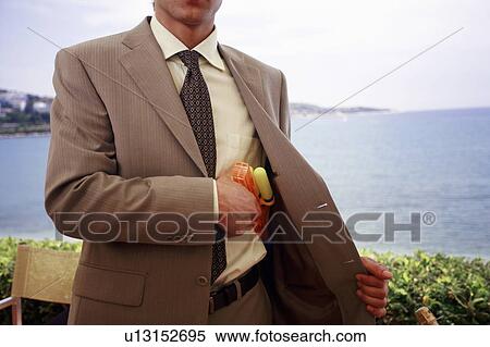 Stock Photography - Businessman with plastic water gun. Fotosearch