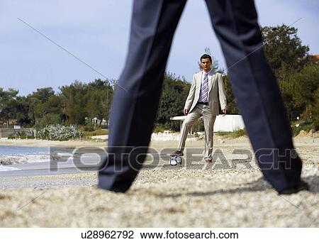 Businessmen on beach playing soccer View Large Photo Image Stock Image - Businessmen on beach playing soccer. Fotosearch
