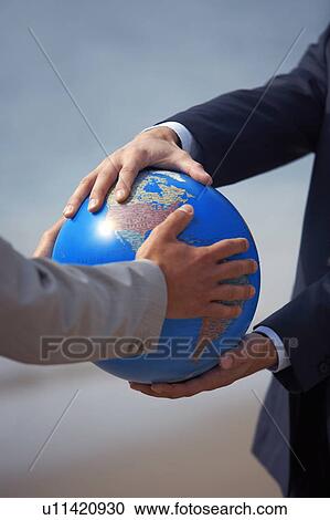 Businessmen's hands grasping globe View Large Photo Image Stock Image - Businessmen's hands grasping globe. Fotosearch