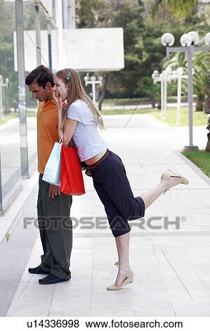 Couple with shopping bags looking at shop window View Large Photo Image Stock Photo - Couple with shopping bags looking at shop window. Fotosearch