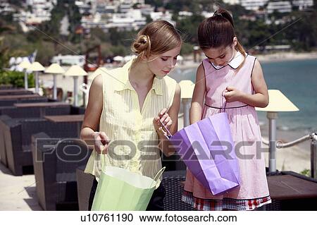 Mother and daughter looking in shopping bag View Large Photo Image Stock Image - Mother and daughter looking in shopping bag. Fotosearch