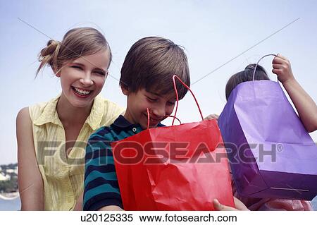 Mother and two children with shopping bags View Large Photo Image Stock Photography - Mother and two children with shopping bags. Fotosearch