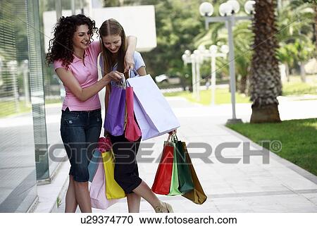 Two women with shopping bags View Large Photo Image Stock Image - Two women with shopping bags. Fotosearch