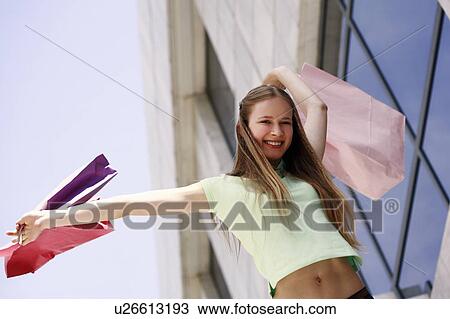 Woman swinging shopping bags View Large Photo Image Stock Image - Woman swinging shopping bags. Fotosearch