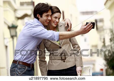 Couple photographing themselves View Large Photo Image Stock Photography - Couple photographing themselves. Fotosearch