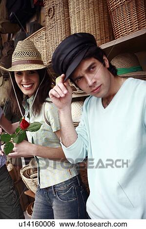 Stock Photograph - Couple posing with hats. Fotosearch