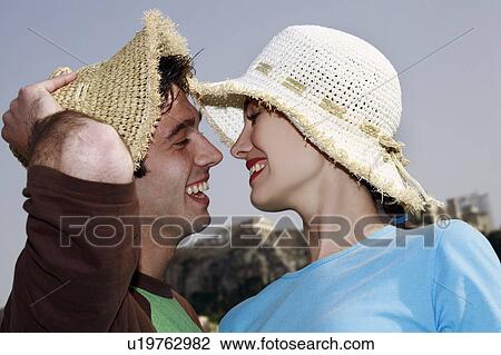 Stock Image - Couple smiling before kissing. Fotosearch