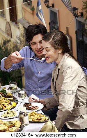 Man feeding woman at restaurant View Large Photo Image Picture - Man feeding woman at restaurant. Fotosearch