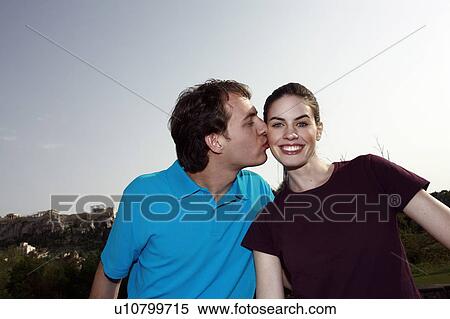 Man kissing woman's cheek View Large Photo Image Stock Photography - Man kissing woman's cheek. Fotosearch