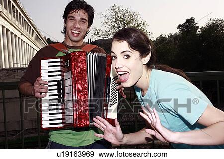 Man playing accordion, woman posing View Large Photo Image Stock Photo - Man playing accordion, woman posing. Fotosearch