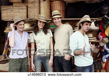 Stock Image - Two couples shopping for hats. Fotosearch