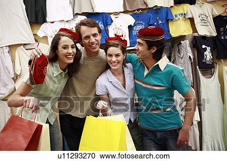 Two couples shopping with Greek costume hats View Large Photo Image Stock Image - Two couples shopping with Greek costume hats. Fotosearch