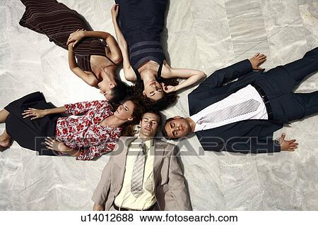 Stock Photo - Business people lying on the ground. Fotosearch