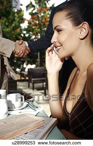 Stock Image - Business people meeting in garden cafe. Fotosearch