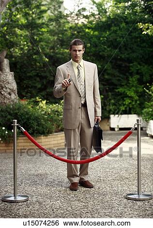 Businessman in garden behind barrier View Large Photo Image Stock Photograph - Businessman in garden behind barrier. Fotosearch