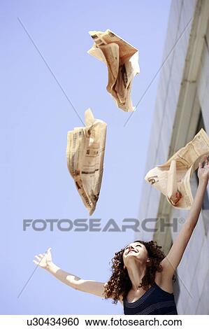 Happy businesswoman throwing newspaper in the air View Large Photo Image Stock Image - Happy businesswoman throwing newspaper in the air. Fotosearch