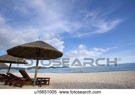 Stock Photography - Beach chair and sunshade on beach, Sanya City, Hainan Province, China. Fotosearch