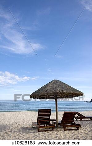 Beach chairs and sunshade on beach View Large Photo Image Stock Photo - Beach chairs and sunshade on beach. Fotosearch