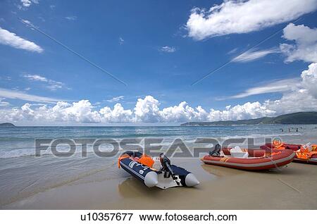 Stock Photo - Motorboat berthing on beach, Sanya City, Hainan Province, China. Fotosearch