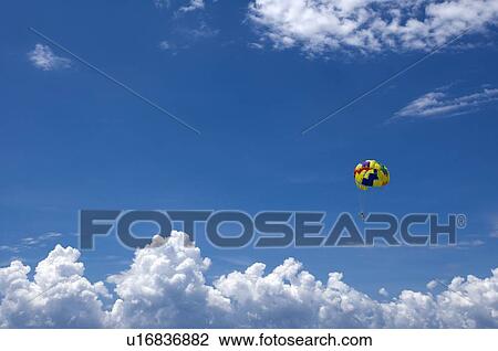 Parachuter flying in the sky View Large Photo Image Stock Image - Parachuter flying in the sky. Fotosearch