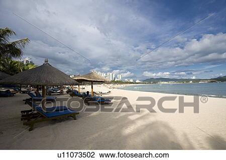 Sunshade and beach chair on beach, Sanya City, Hainan Province, China View Large Photo Image Stock Image - Sunshade and beach chair on beach, Sanya City, Hainan Province, China. Fotosearch