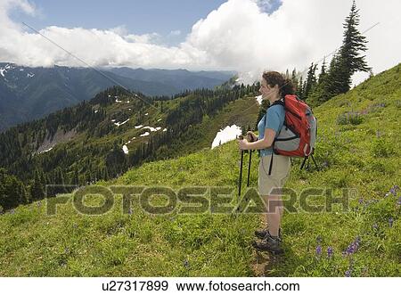 Stock Photo - A woman hiker on the High Divide Trail on Olympic National Park. Fotosearch
