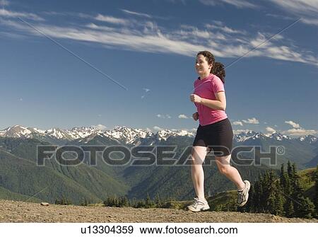 Stock Photo - A woman trail running on Hurricane Ridge, Olympic National Park. Fotosearch